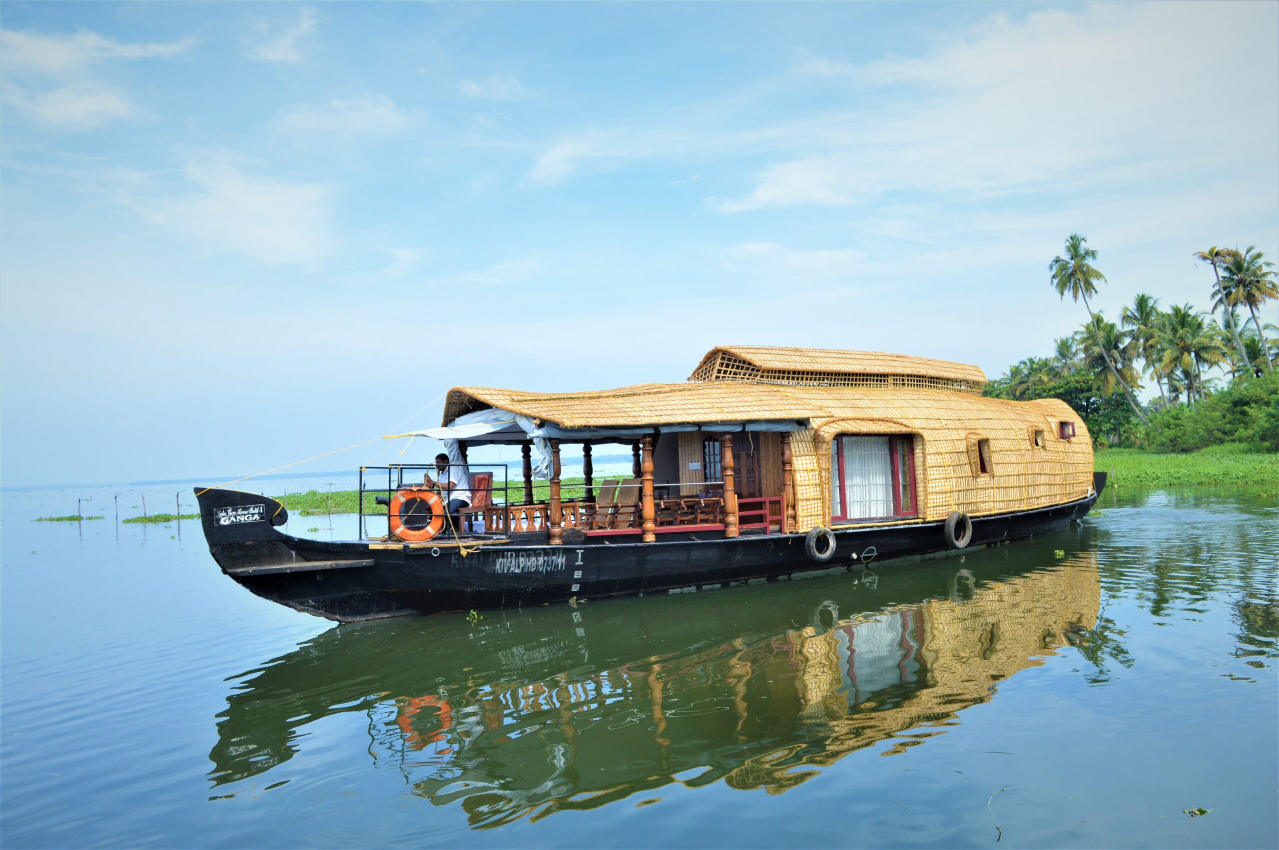 A traditional houseboat cruising the Kerala backwaters
